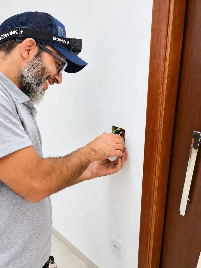Sr. Garcia trabalhando em um ponto elétrico na parede